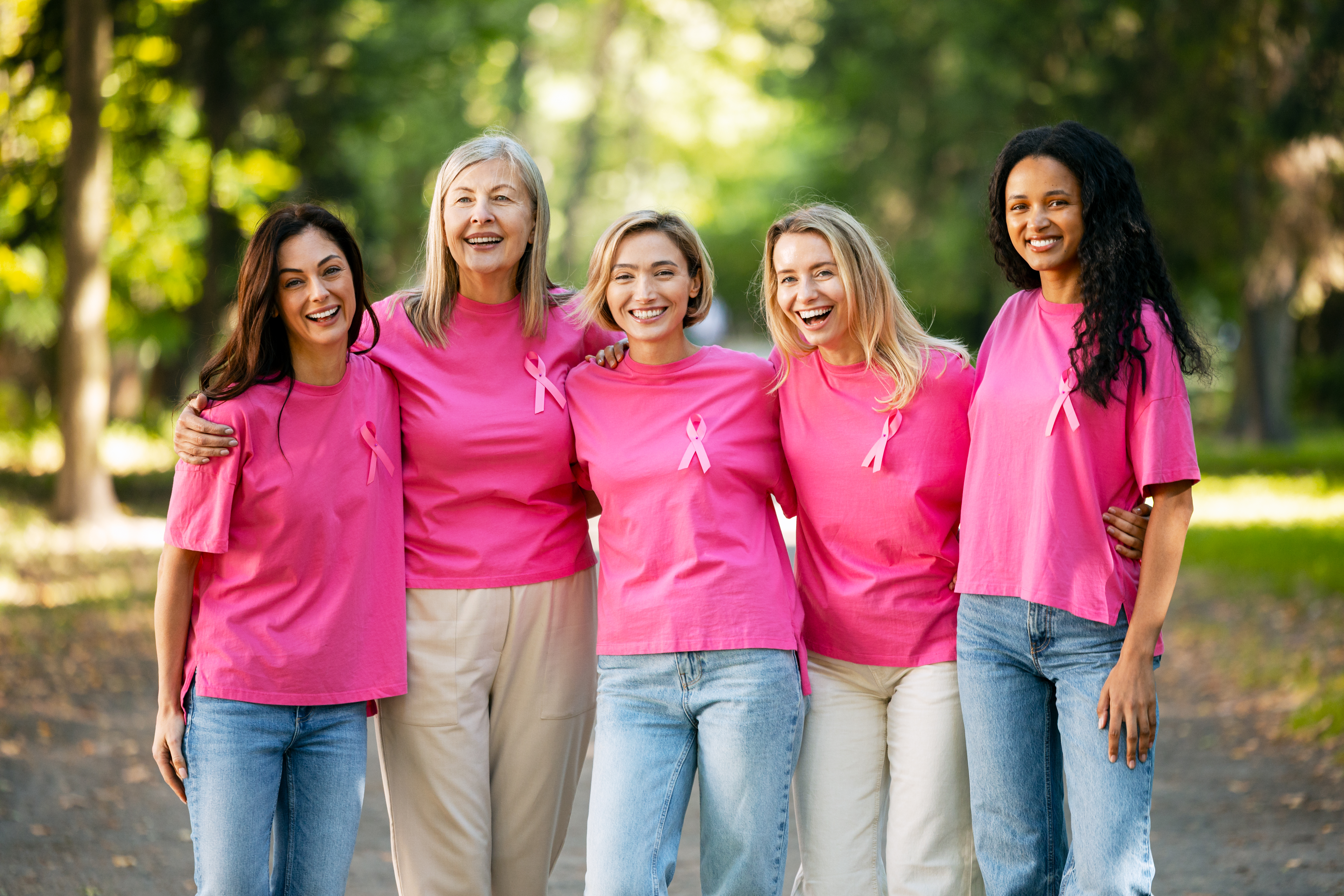 Women wearing pink shirts and ribbons
